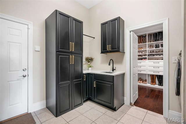 4304 Austin Pass Ct, Saint Charles, MO 63304 - kitchen with light countertops, light tile patterned floors, and dark cabinetry