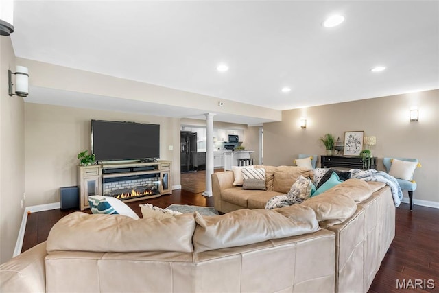 4304 Austin Pass Ct, Saint Charles, MO 63304 - living room with dark wood-style flooring, a lit fireplace, ornate columns, and recessed lighting