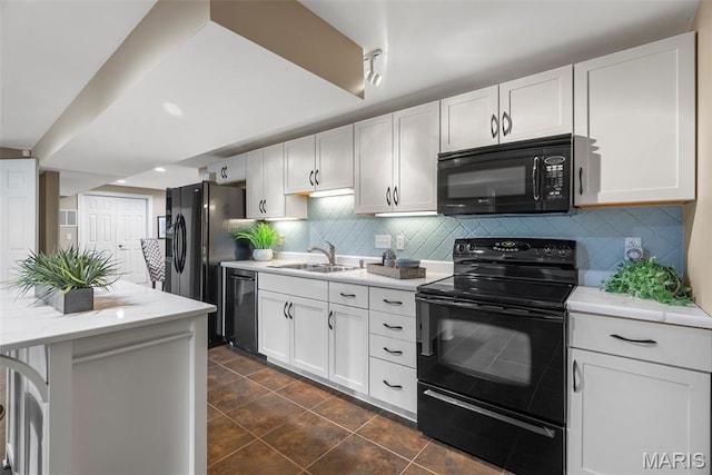 4304 Austin Pass Ct, Saint Charles, MO 63304 - kitchen featuring black appliances, white cabinetry, and decorative backsplash