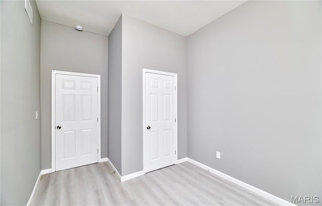 4275 E Ashland Ave, Saint Louis, MO 63115 - unfurnished bedroom featuring light wood-style floors and baseboards