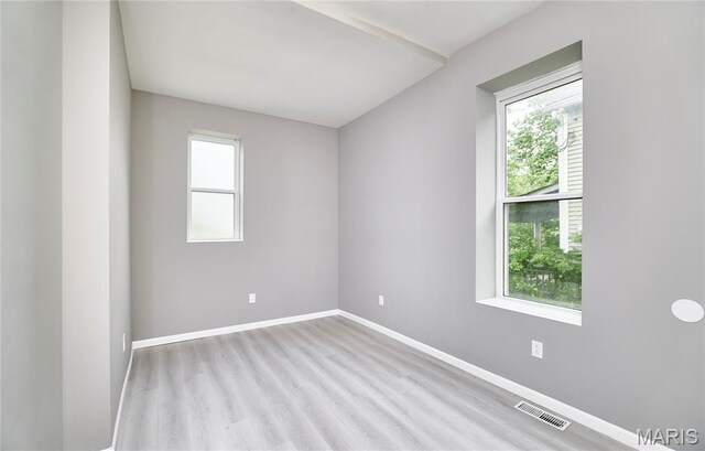 4275 E Ashland Ave, Saint Louis, MO 63115 - empty room with healthy amount of natural light and wood finished floors