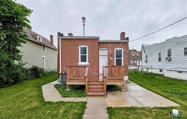 4275 E Ashland Ave, Saint Louis, MO 63115 - back of property featuring a chimney, a yard, brick siding, and a wooden deck