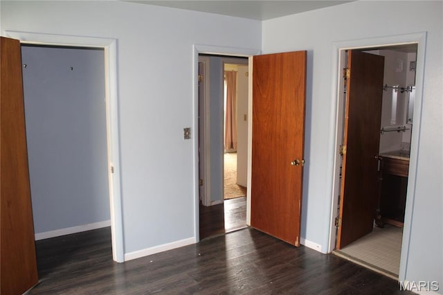 4 Primrose Ln, Fairview Heights, IL 62208 - unfurnished bedroom with wood finished floors, a closet, and connected bathroom