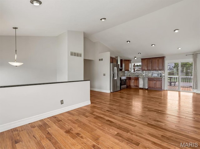 3178 5 Oaks Dr, Arnold, MO 63010 - unfurnished living room with vaulted ceiling, light wood-type flooring, and recessed lighting