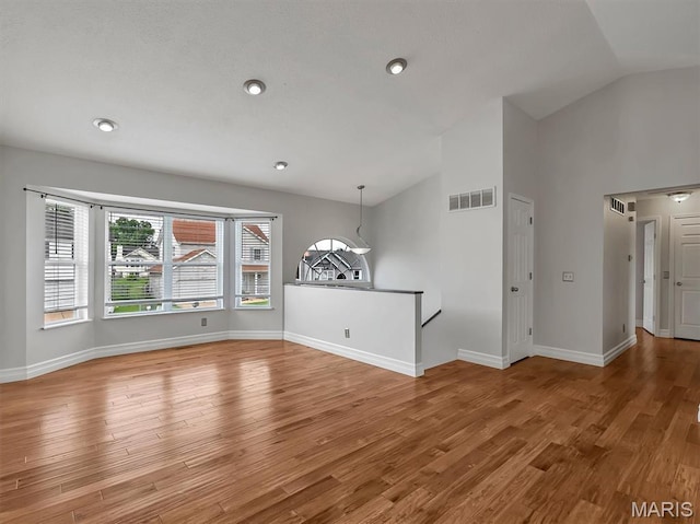 3178 5 Oaks Dr, Arnold, MO 63010 - spare room featuring vaulted ceiling, wood finished floors, and recessed lighting