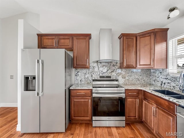 3178 5 Oaks Dr, Arnold, MO 63010 - kitchen featuring appliances with stainless steel finishes, wall chimney range hood, lofted ceiling, backsplash, and brown cabinets