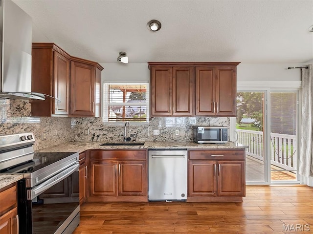 3178 5 Oaks Dr, Arnold, MO 63010 - kitchen with stainless steel appliances, wall chimney exhaust hood, healthy amount of natural light, and backsplash
