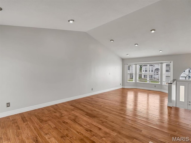3178 5 Oaks Dr, Arnold, MO 63010 - unfurnished living room with vaulted ceiling, light wood-style floors, and recessed lighting