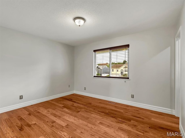 3178 5 Oaks Dr, Arnold, MO 63010 - unfurnished room with wood finished floors and a textured ceiling