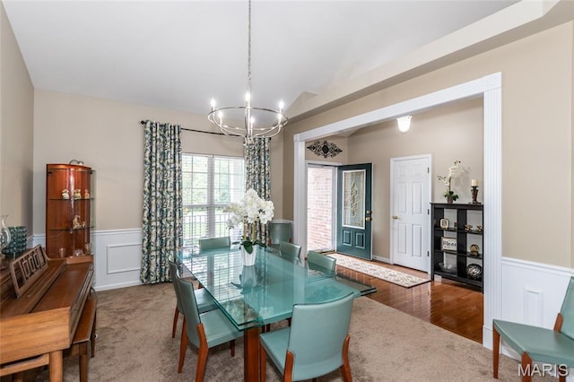 221 Meriwether Lewis Dr, Ofallon, MO 63368 - dining area featuring a chandelier, a wainscoted wall, and a decorative wall