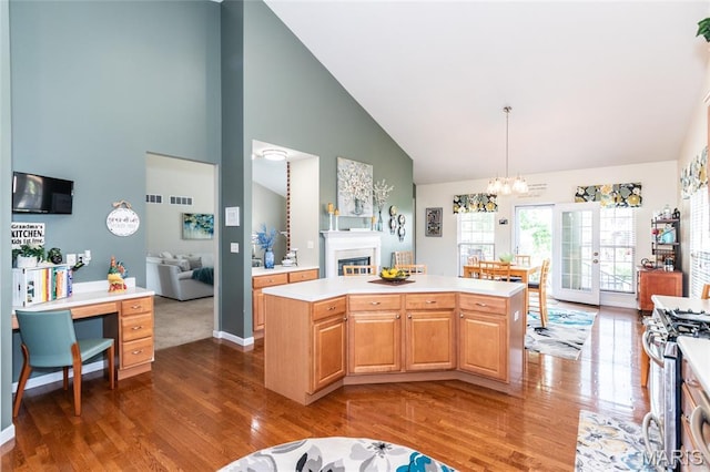 221 Meriwether Lewis Dr, Ofallon, MO 63368 - kitchen with gas range, dark wood-type flooring, high vaulted ceiling, light countertops, and a chandelier