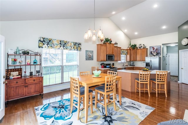 221 Meriwether Lewis Dr, Ofallon, MO 63368 - dining area with high vaulted ceiling, a chandelier, plenty of natural light, dark wood-type flooring, and recessed lighting