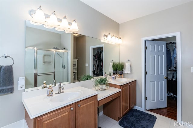 221 Meriwether Lewis Dr, Ofallon, MO 63368 - bathroom with vanity, a shower stall, a walk in closet, and tile patterned flooring