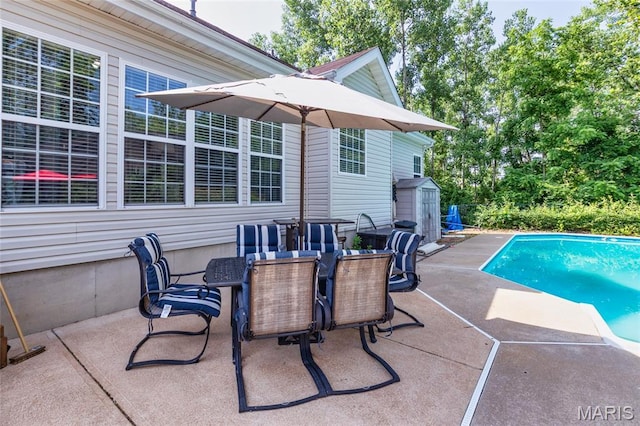 221 Meriwether Lewis Dr, Ofallon, MO 63368 - view of patio / terrace featuring a storage unit, outdoor dining space, and an outdoor pool