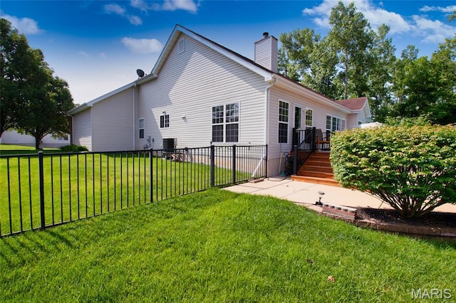 221 Meriwether Lewis Dr, Ofallon, MO 63368 - back of property with a chimney, a wooden deck, and a patio