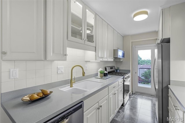4466 W Pine Blvd Unit 7D, Saint Louis, MO 63108 - kitchen with stainless steel appliances, white cabinetry, and backsplash