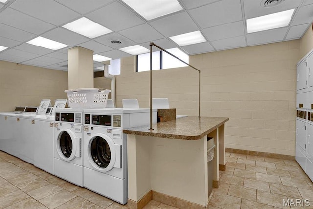 4466 W Pine Blvd Unit 7D, Saint Louis, MO 63108 - community laundry featuring washing machine and clothes dryer and concrete block wall