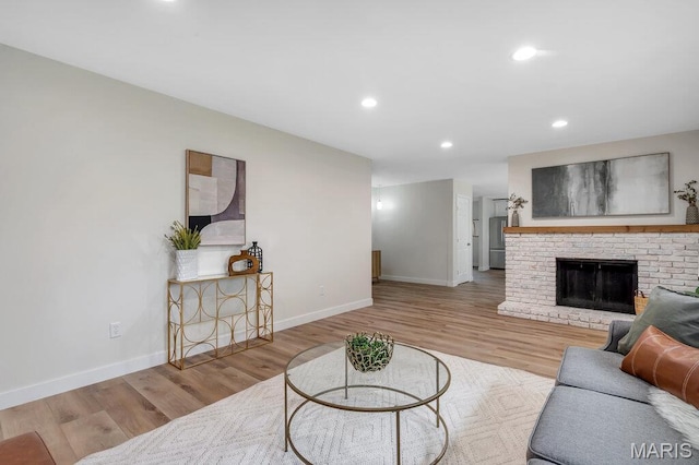 1254 Jade Wind Cir, Ballwin, MO 63011 - living area featuring wood finished floors, recessed lighting, and a fireplace
