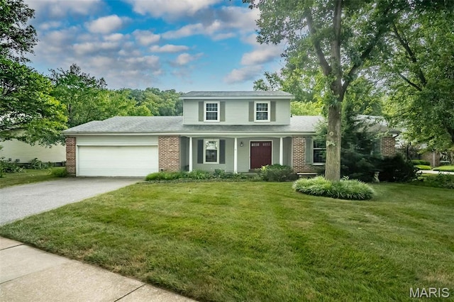 14898 Pheasant Hill Ct, Chesterfield, MO 63017 - traditional home with a garage, brick siding, concrete driveway, and a front lawn