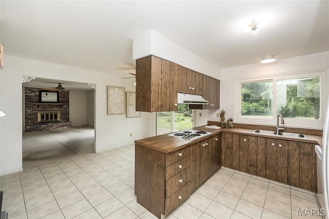 14898 Pheasant Hill Ct, Chesterfield, MO 63017 - kitchen with ceiling fan, light tile patterned flooring, exhaust hood, white cooktop, and a brick fireplace