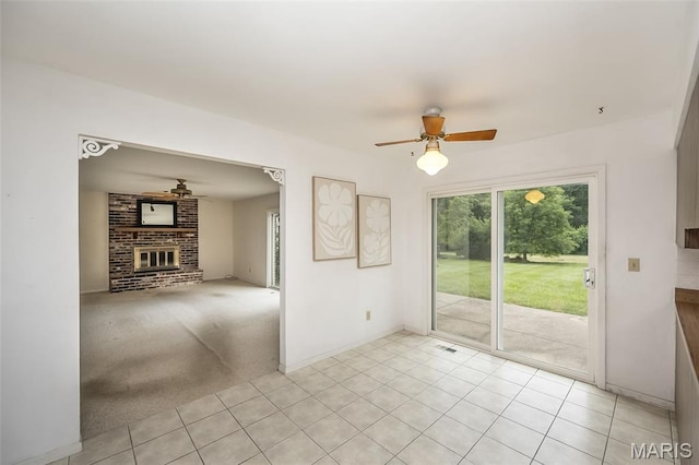 14898 Pheasant Hill Ct, Chesterfield, MO 63017 - spare room with ceiling fan, a brick fireplace, and light tile patterned flooring