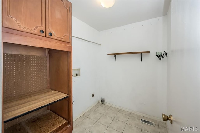 14898 Pheasant Hill Ct, Chesterfield, MO 63017 - washroom featuring cabinet space, hookup for a washing machine, and light tile patterned flooring