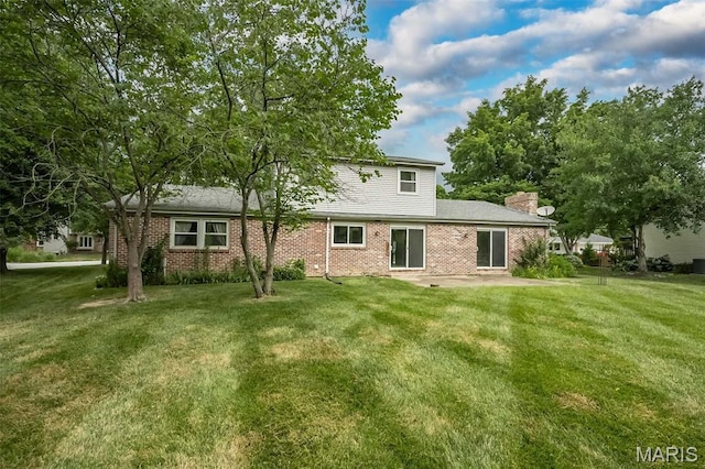 14898 Pheasant Hill Ct, Chesterfield, MO 63017 - back of property featuring brick siding, a lawn, and a patio area