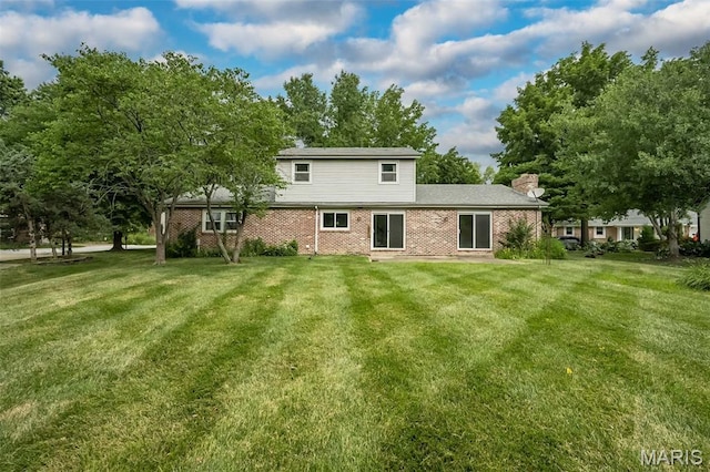 14898 Pheasant Hill Ct, Chesterfield, MO 63017 - back of house with a lawn, brick siding, and a chimney