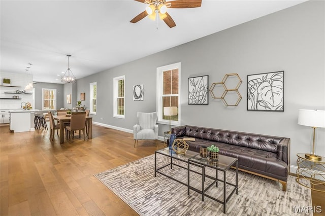 3400 Vista Ave, Saint Louis, MO 63104 - living area with wood finished floors, a ceiling fan, and a chandelier