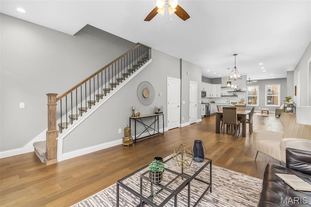 3400 Vista Ave, Saint Louis, MO 63104 - living area with stairway, a ceiling fan, dark wood-style floors, a chandelier, and recessed lighting