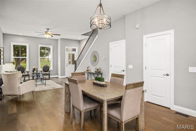 3400 Vista Ave, Saint Louis, MO 63104 - dining area with ceiling fan, dark wood-style floors, a chandelier, stairway, and recessed lighting