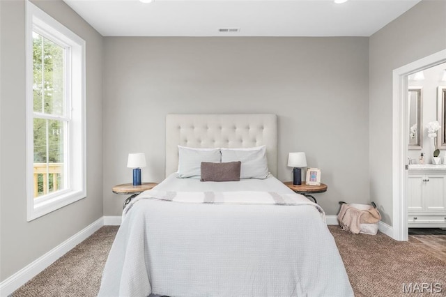 3400 Vista Ave, Saint Louis, MO 63104 - carpeted bedroom featuring multiple windows and ensuite bathroom