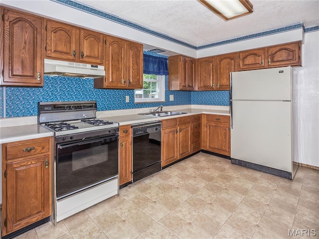 9 Richard St, Waterloo, IL 62298 - kitchen featuring freestanding refrigerator, gas range oven, under cabinet range hood, dishwasher, and a textured ceiling