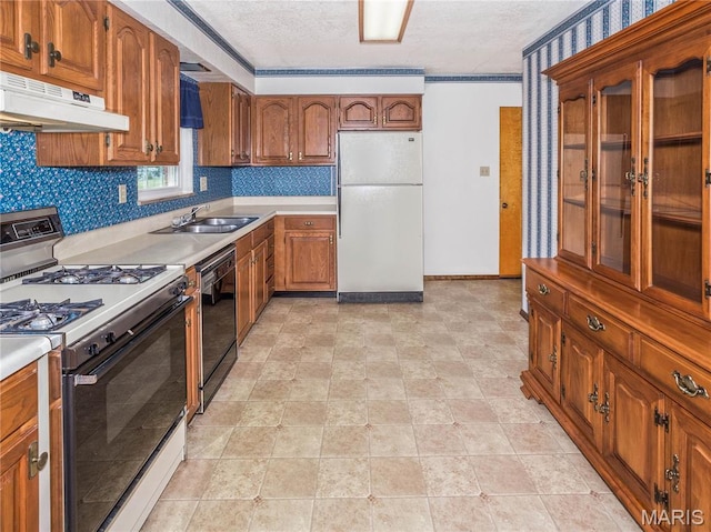 9 Richard St, Waterloo, IL 62298 - kitchen featuring freestanding refrigerator, gas range, under cabinet range hood, dishwasher, and brown cabinets