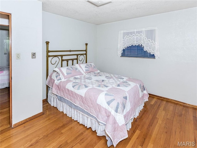 9 Richard St, Waterloo, IL 62298 - bedroom featuring wood finished floors and a textured ceiling