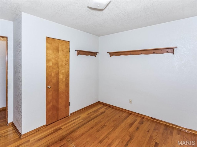 9 Richard St, Waterloo, IL 62298 - empty room with light wood finished floors and a textured ceiling