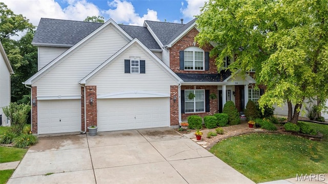 24 Milton Brennan Manor Ct, Wentzville, MO 63385 - traditional-style home featuring brick siding, driveway, a front lawn, and a shingled roof