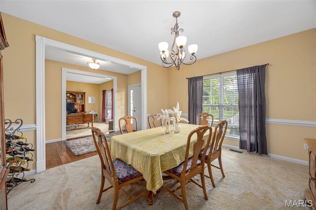 24 Milton Brennan Manor Ct, Wentzville, MO 63385 - dining area featuring light carpet and a chandelier