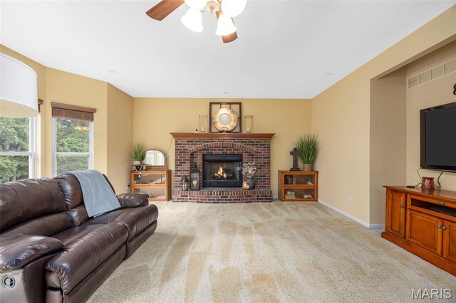 24 Milton Brennan Manor Ct, Wentzville, MO 63385 - carpeted living area featuring a ceiling fan and a brick fireplace