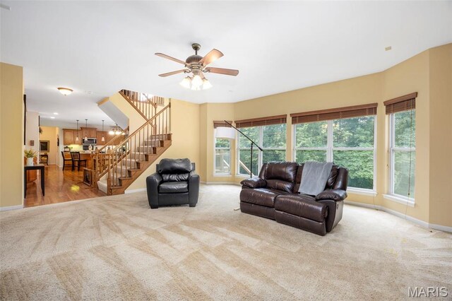 24 Milton Brennan Manor Ct, Wentzville, MO 63385 - living room with light carpet, stairway, and ceiling fan
