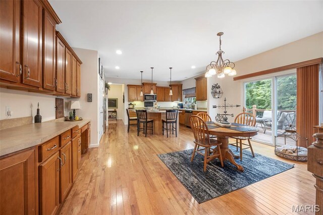 24 Milton Brennan Manor Ct, Wentzville, MO 63385 - dining space with light wood-type flooring, recessed lighting, and a chandelier