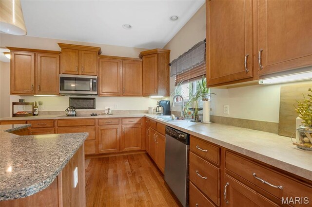 24 Milton Brennan Manor Ct, Wentzville, MO 63385 - kitchen with appliances with stainless steel finishes, light wood-style floors, brown cabinetry, light stone counters, and recessed lighting