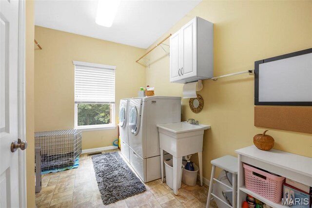 24 Milton Brennan Manor Ct, Wentzville, MO 63385 - washroom featuring cabinet space and washer and dryer