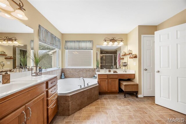 24 Milton Brennan Manor Ct, Wentzville, MO 63385 - bathroom with a stall shower, two vanities, a bath, and stone finish flooring