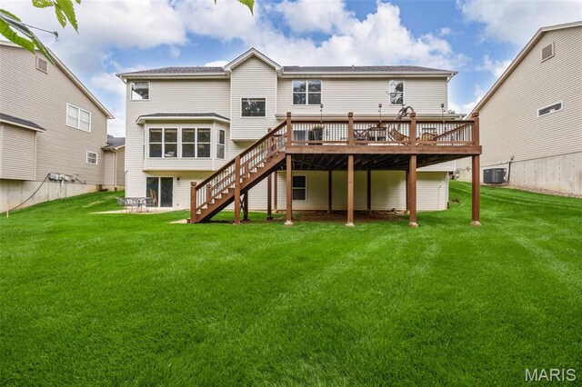 24 Milton Brennan Manor Ct, Wentzville, MO 63385 - back of property with a deck, stairway, and a lawn