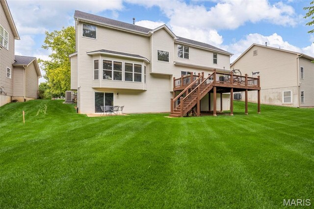 24 Milton Brennan Manor Ct, Wentzville, MO 63385 - rear view of house featuring a wooden deck, stairway, and a yard