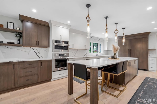 1607 Wyncliff Ln, Frontenac, MO 63131 - kitchen with light countertops, recessed lighting, tasteful backsplash, and decorative light fixtures