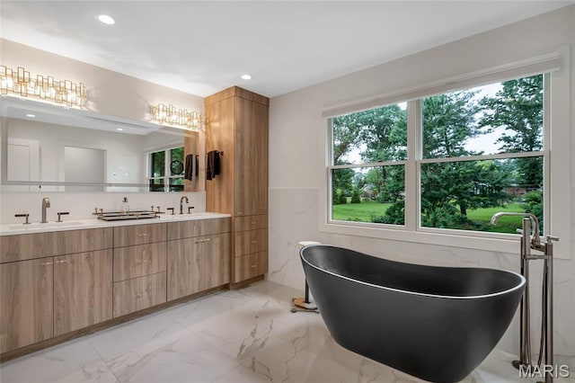 1607 Wyncliff Ln, Frontenac, MO 63131 - full bath with double vanity, marble finish flooring, a freestanding tub, and recessed lighting