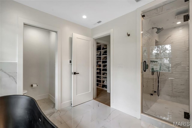 1607 Wyncliff Ln, Frontenac, MO 63131 - full bathroom featuring a stall shower, marble finish floors, a spacious closet, a freestanding tub, and recessed lighting