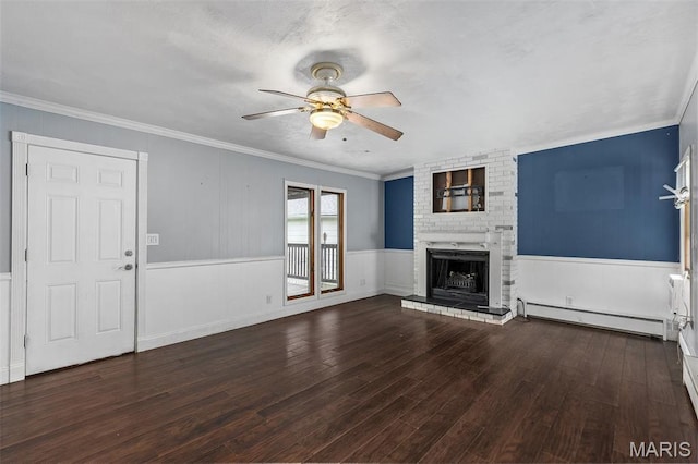 912 N Illinois Ave, Litchfield, IL 62056 - unfurnished living room with a baseboard radiator, ceiling fan, wood finished floors, a fireplace, and wainscoting